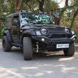 A black Mahindra Thar 4x4 SUV with Ironman4x4 Nitro Gas Suspension installed, parked outdoors.