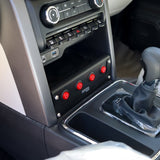 Close-up of a car's center console with control buttons and gear shift.